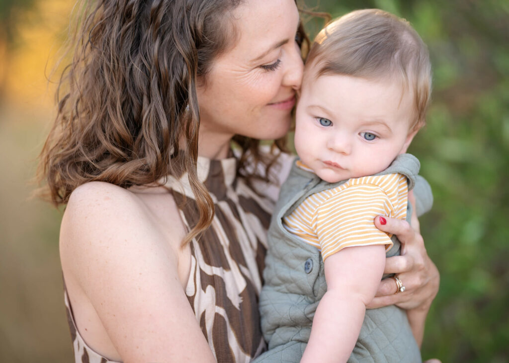 Mum holding her baby during outdoor family photoshoot in Melbourne