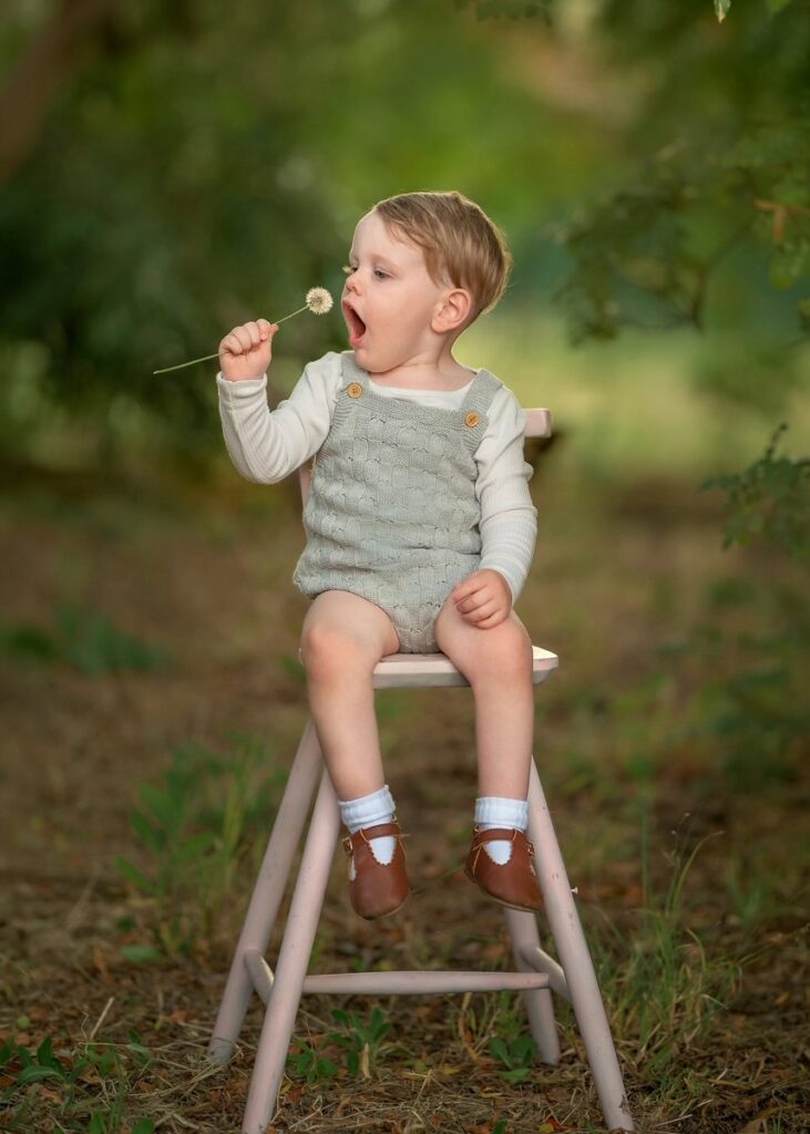 Young boy sitting on a wooden chair during a Perth children's portrait session in Swan Valley