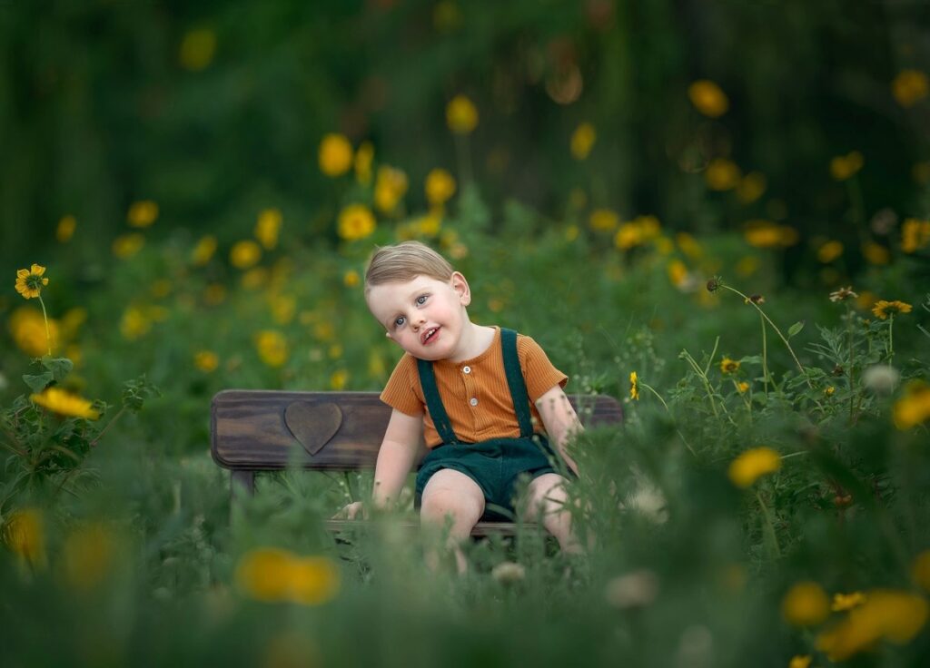 Young boy among yellow wildflowers, Perth children's portrait session in Swan Valley