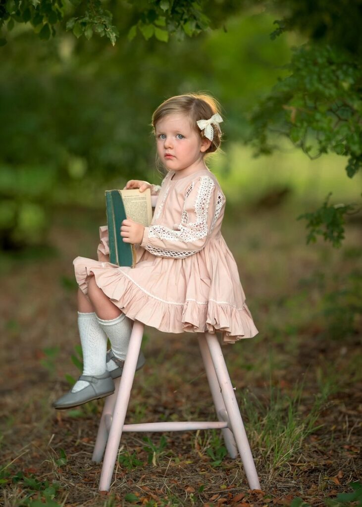 Young girl reading during a Perth children's portrait session in Swan Valley
