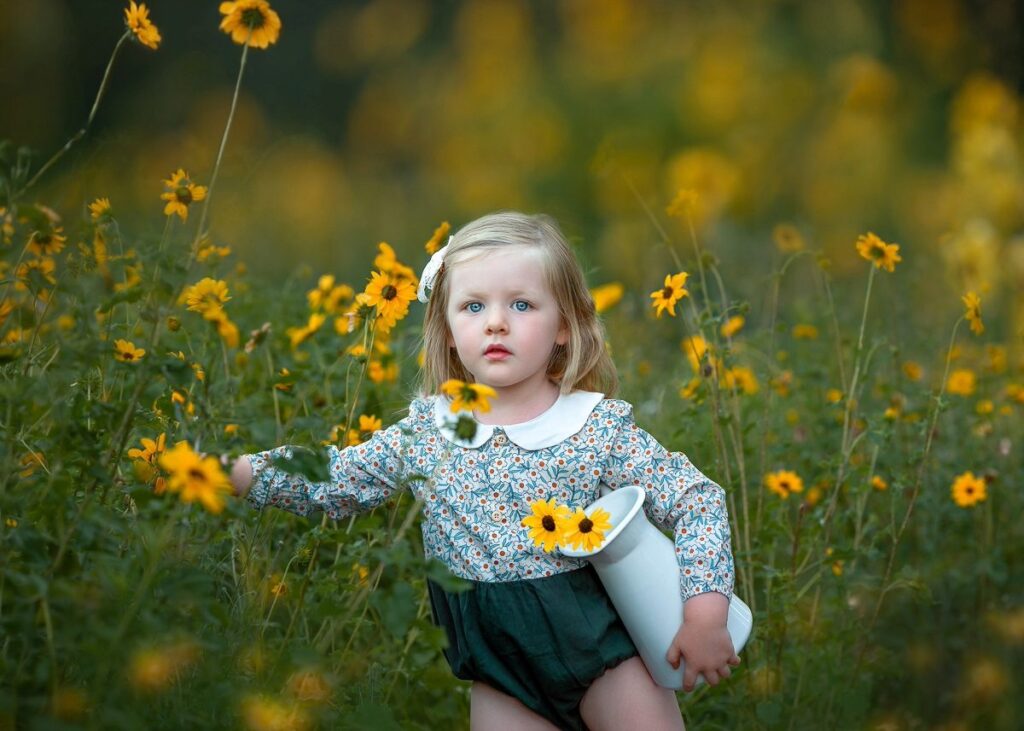 Young girl among yellow wildflowers during a Perth children's portrait session in Swan Valley