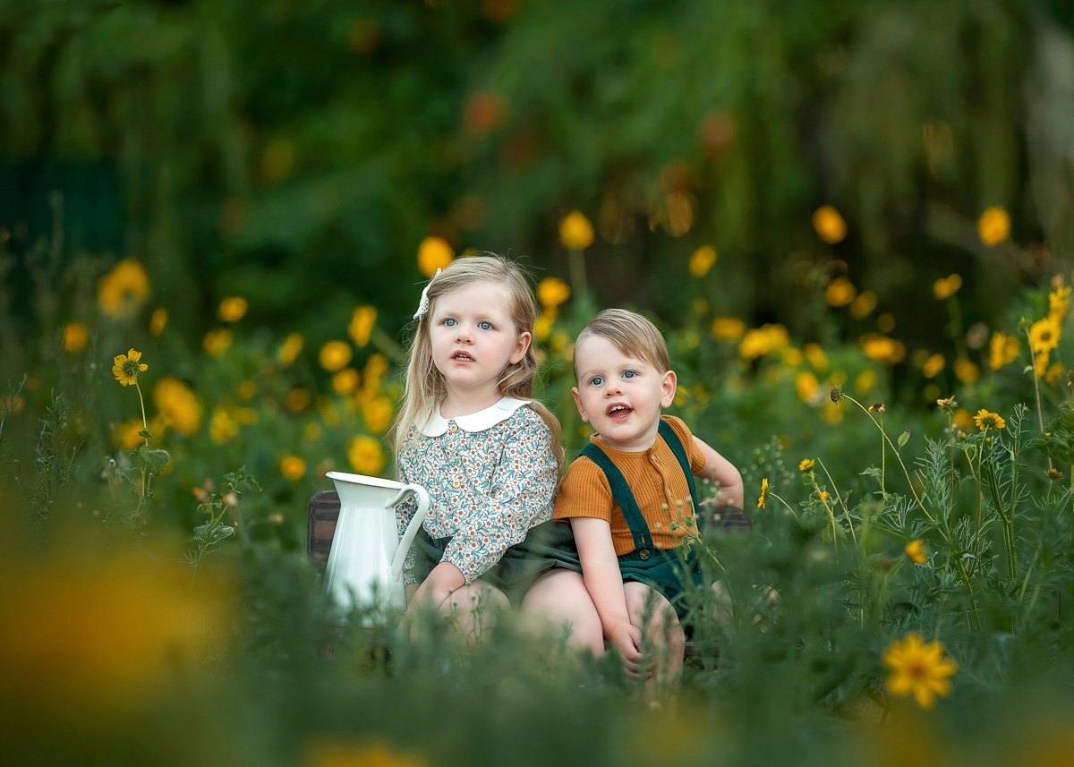 Siblings among yellow wildflowers during a Perth sibling portraits session in Swan Valley